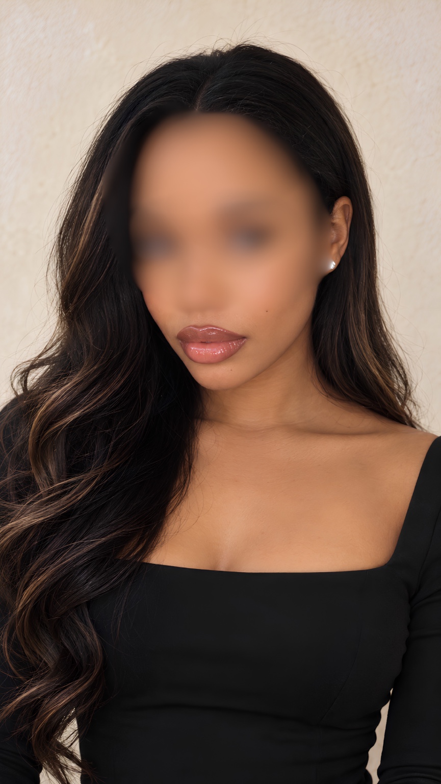 A close-up of Milani in a black dress